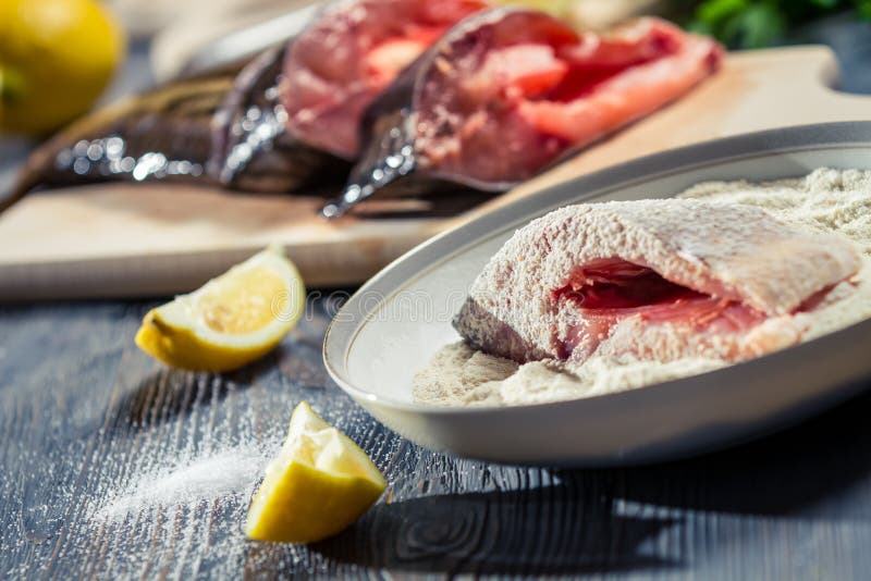 Fresh Fish Dipped in Flour and Seasoned with Lemon Stock Photo Image