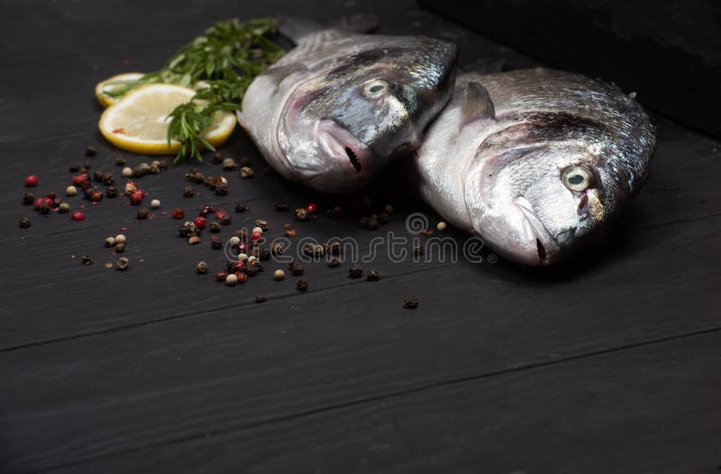 Fresh Fish Dorado. Dorado and Ingredients for Cooking on a Table. Stock