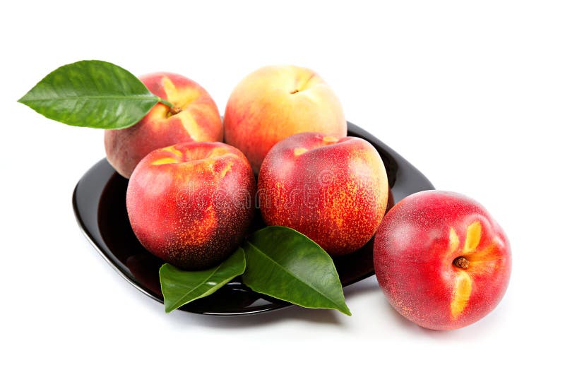 Fresh Fruit Nectarines and Peaches with Green Leaves. Stock Image