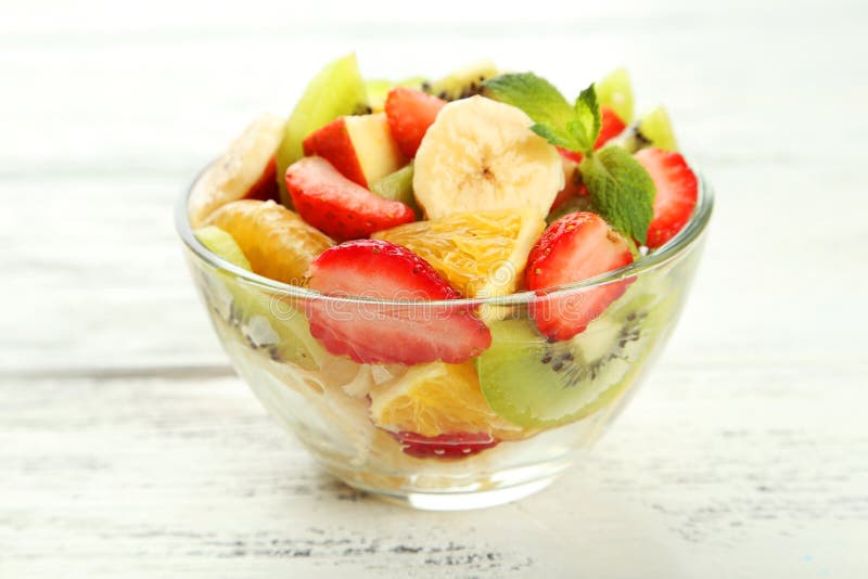 Fresh Fruit Salad in Bowl on a White Wooden Background Stock Image