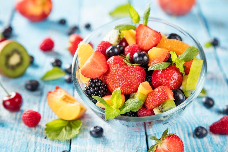 Fresh fruit salad served on wooden table