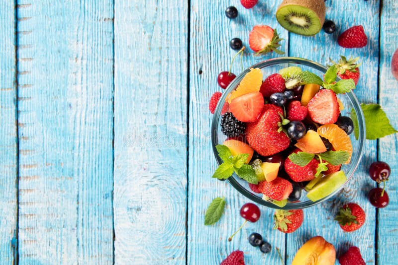 Fresh fruit salad served on wooden table