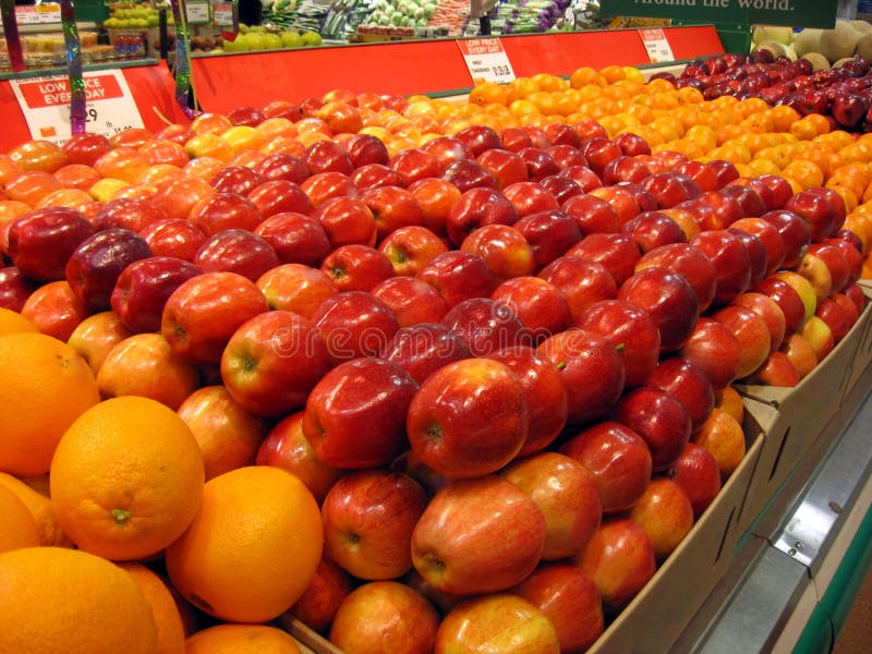 Rows of fresh oranges and apples in a grocery store. Rows of fresh oranges and apples in a grocery store
