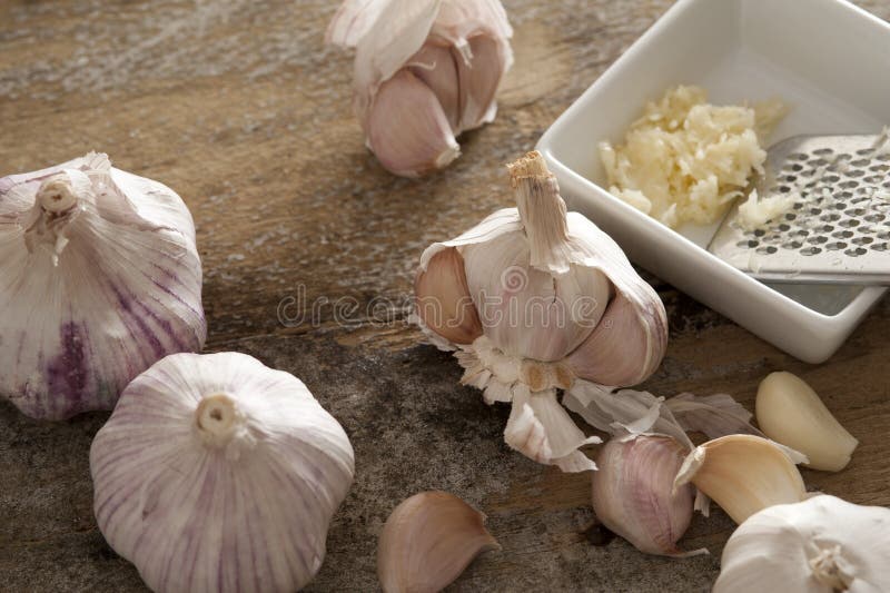 Fresh garlic bulbs and grater