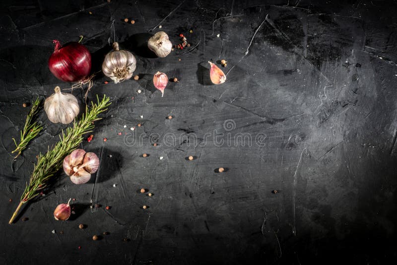 Fresh garlic and onion on dark background