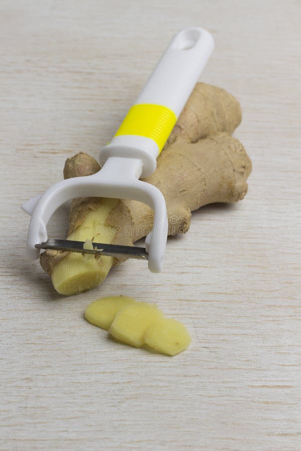 Fresh ginger, whole and sliced on white background. Herbal therapy concept