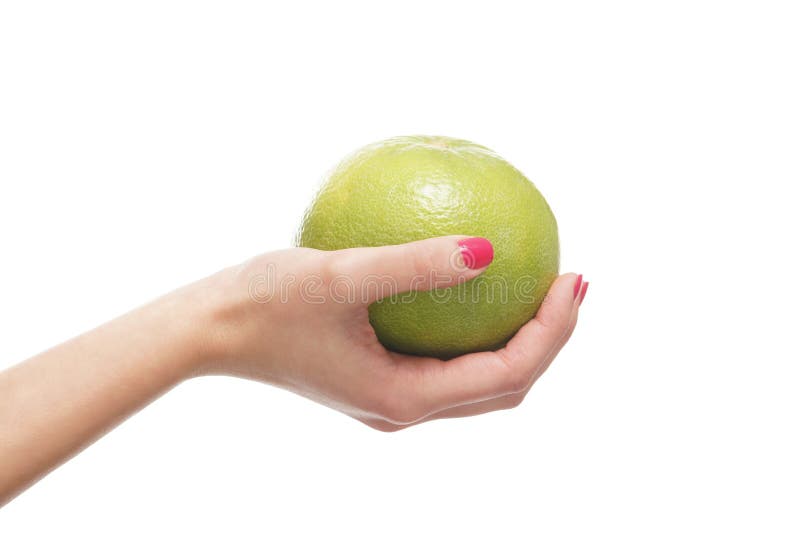 A fresh grapefruit held in beautiful female hands on white