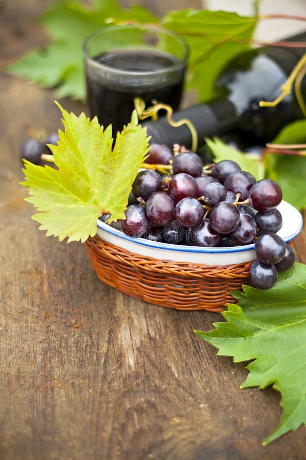 Fresh grapes and bottles of wine