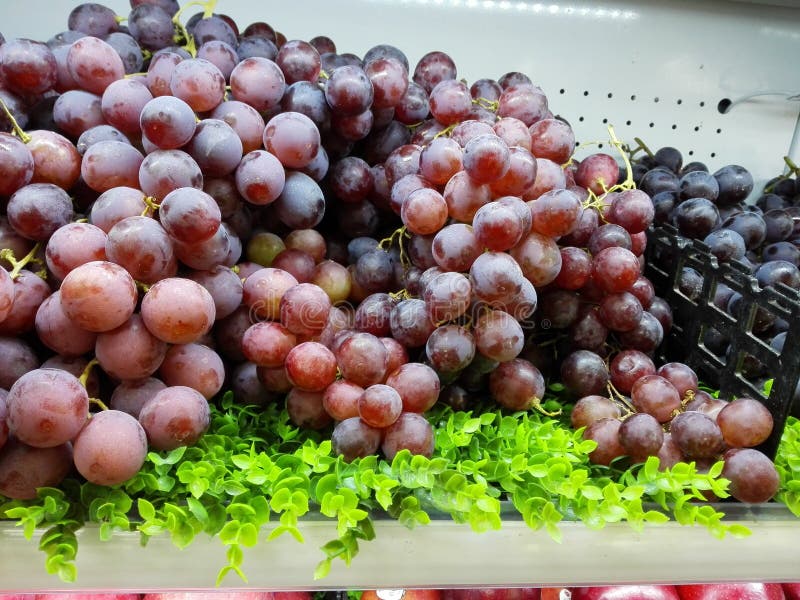 Fresh grapes are placed at the supermarket counter for sale