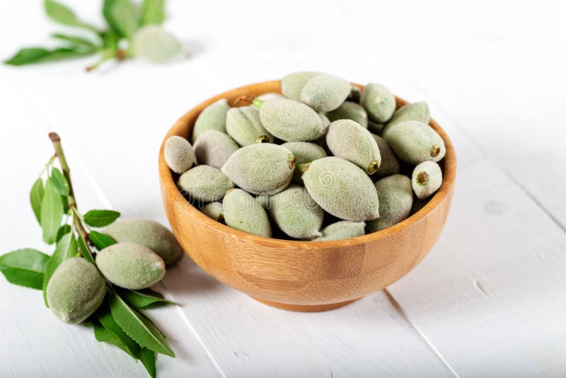 Fresh green almonds in a wooden bowl stock photo Fresh green almonds in a wooden bowl stock photo
