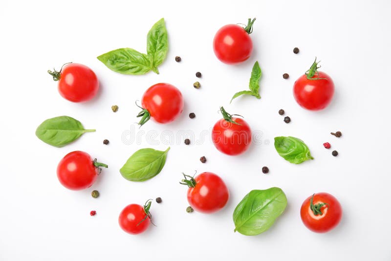 Fresh green basil leaves and cherry tomatoes on white background