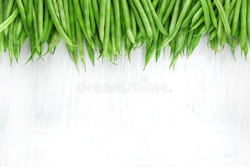 Fresh green beans on white wooden kitchen plate, shabby chic