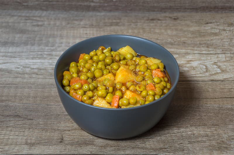 Fresh green peas with tomato sauce potatoes and carrot Greek food