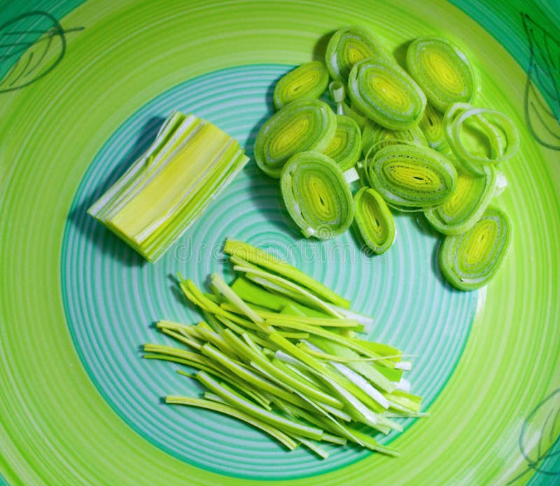 Fresh sliced leek on a green background. stock photo