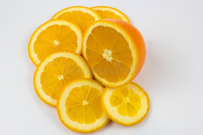 A half orange and slices on white background stock image