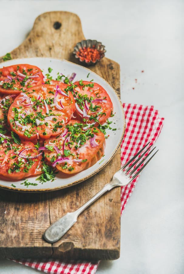 Fresh heirloom tomato, parsley and onion salad. Vegan food concept stock image Fresh heirloom tomato, parsley and onion salad. Vegan food concept stock image