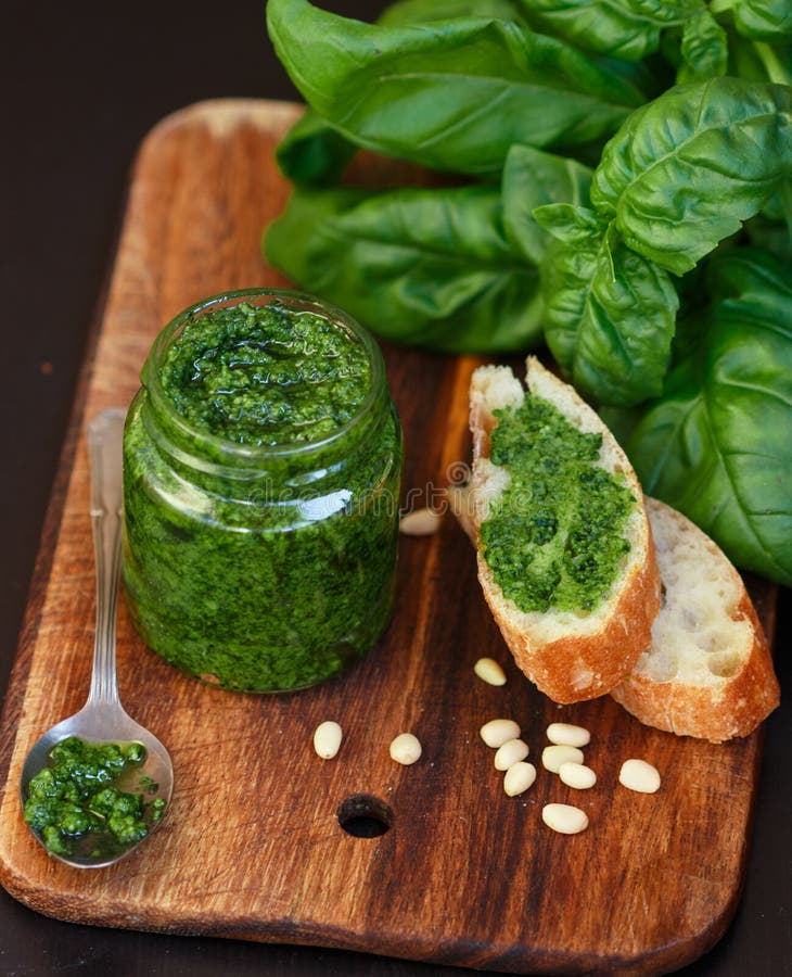 Fresh Homemade Basil Pesto with Pine Nuts in a Glass Jar , Basil Leaf