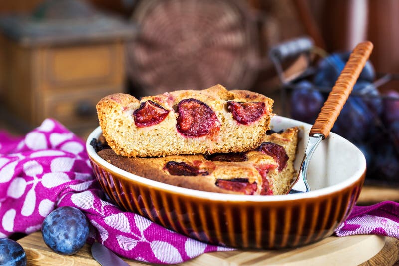 Fresh homemade dimply plum cake on rustic background