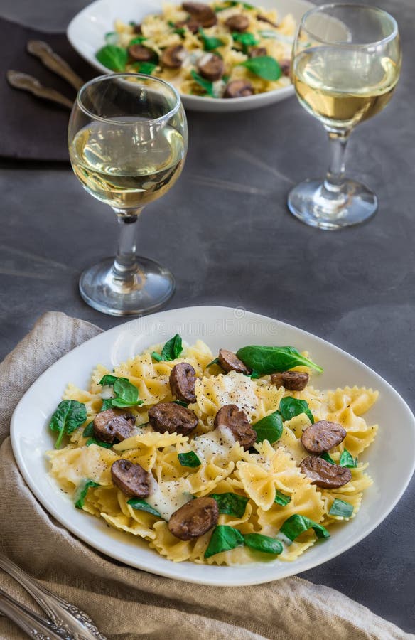 Farfalle Pasta with Mushrooms and Spinach Stock Photo - Image of napkin