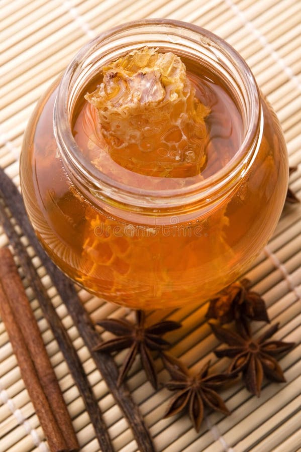 Fresh honey with honeycomb and spices
