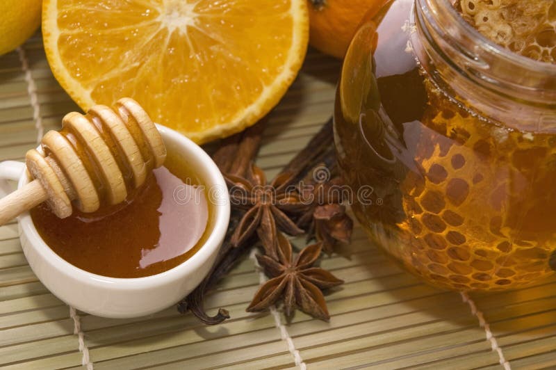 Fresh honey with honeycomb, spices and fruits