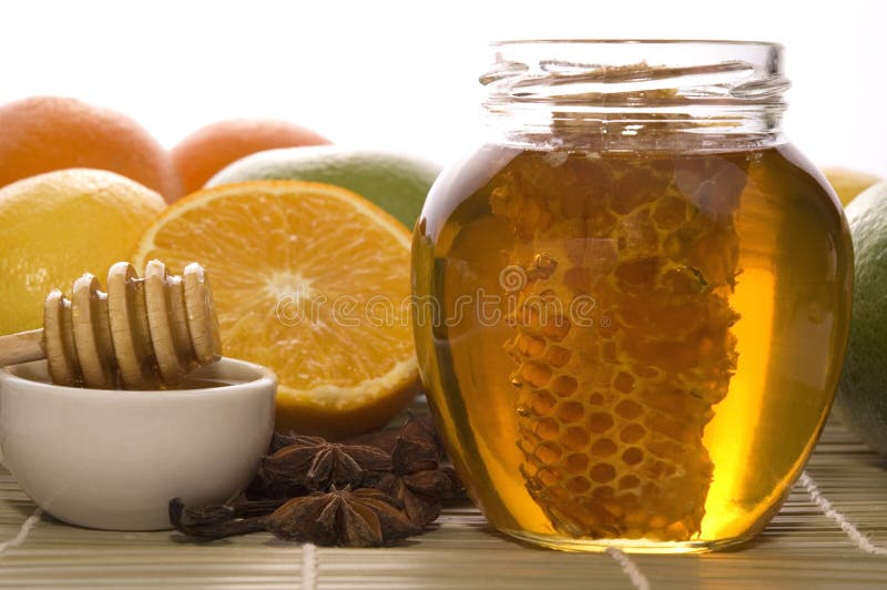 Fresh honey with honeycomb, spices and fruits