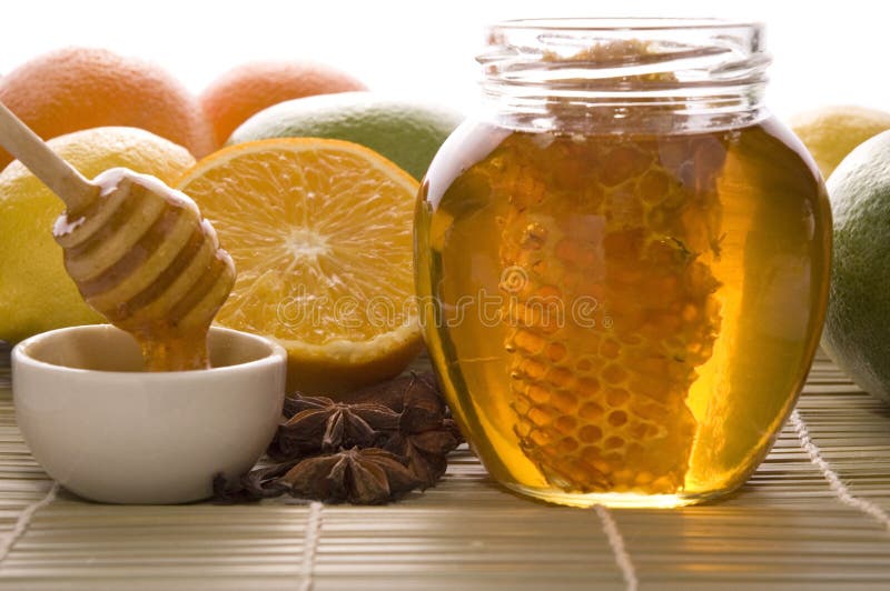 Fresh honey with honeycomb, spices and fruits