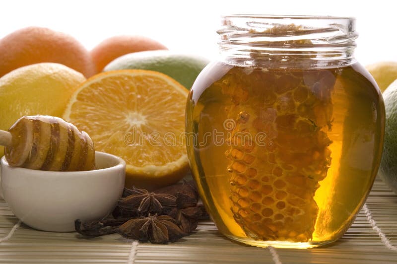 Fresh honey with honeycomb, spices and fruits