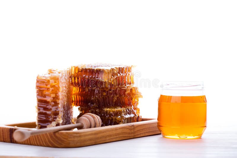 Fresh honeycomb and honey dipper on white background stock image Fresh honeycomb and honey dipper on white background stock image