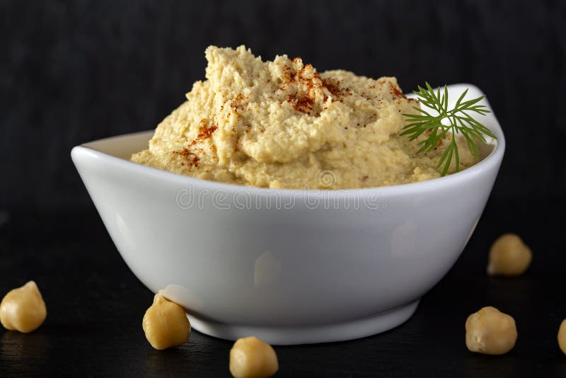 Fresh hummus in bowl stock image. Image of slate, paprika 178425033