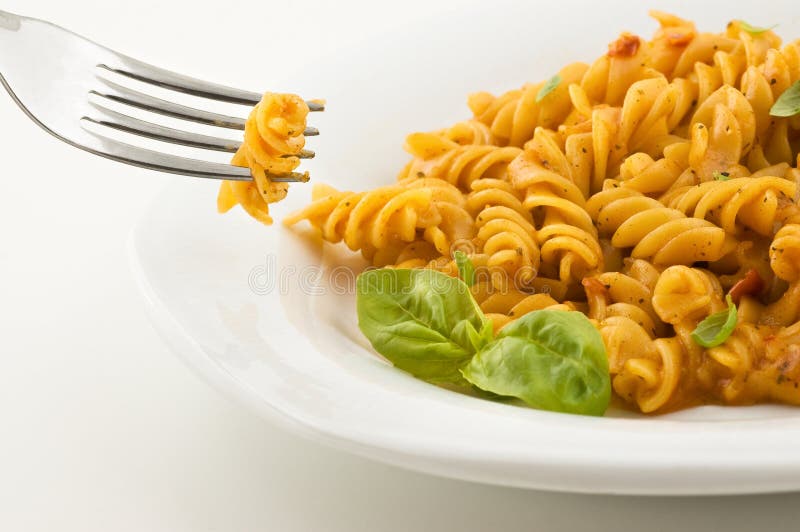 Fresh italian pasta with tomato sauce and basil.