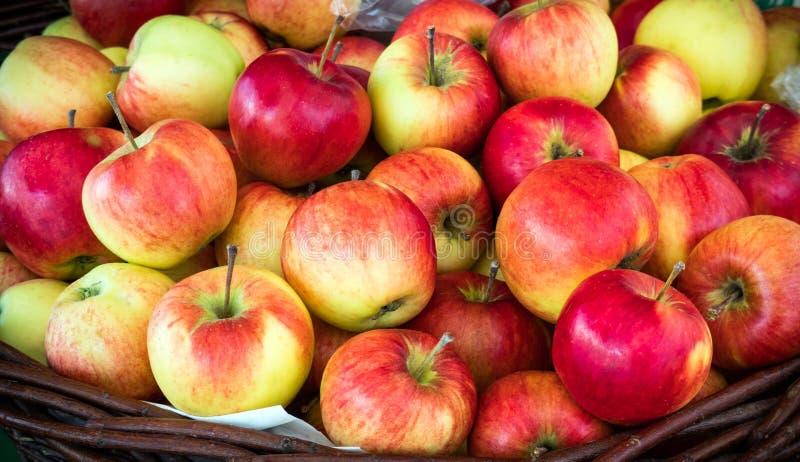 Fresh Juicy Red Apples Stack in a Basket on sale. Beautiful Natural Background