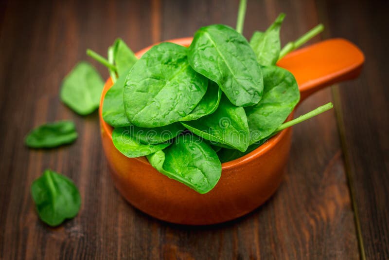 Fresh Juicy Spinach Leaves on a Wooden Brown Table. Natural Products