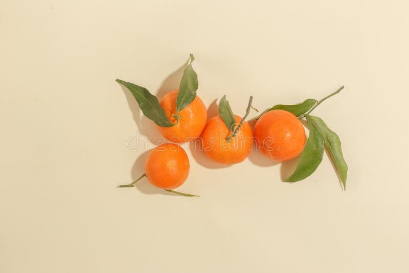 Fresh juicy tangerines on a yellow background. Summer mood, healthy food. Top view