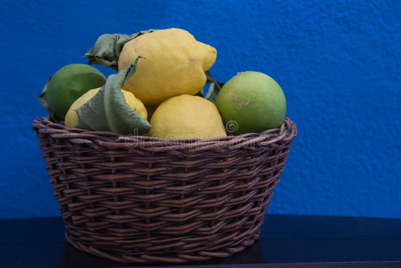 Fresh lemon in a wicker basket on a blue background royalty free stock photo Fresh lemon in a wicker basket on a blue background royalty free stock photo