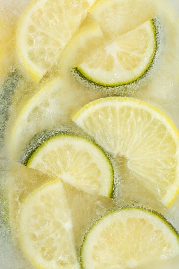 Fresh Lemons and Lime Slices Frozen in Ice Cube on White Background ...