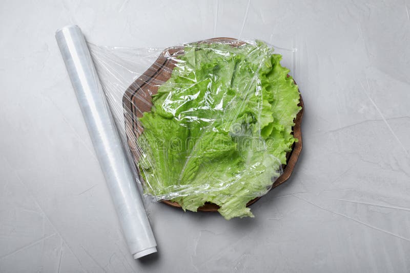 Fresh Lettuce with Plastic Food Wrap on Light Grey Table, Flat Lay Stock Image Image of flat
