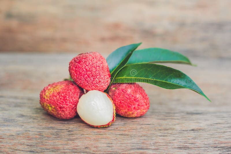 Fresh litchi fruit on an old wooden background