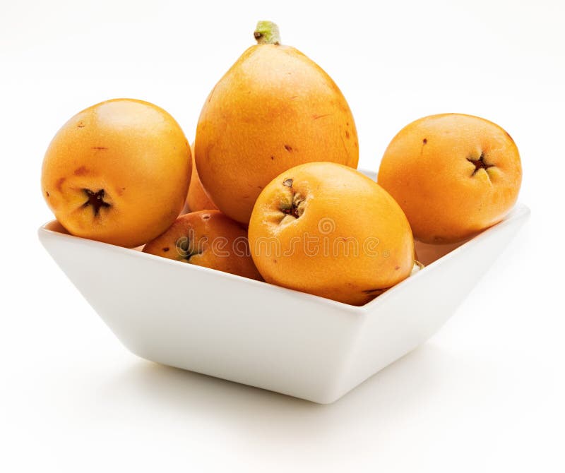 Fresh loquats medlars in bowl.