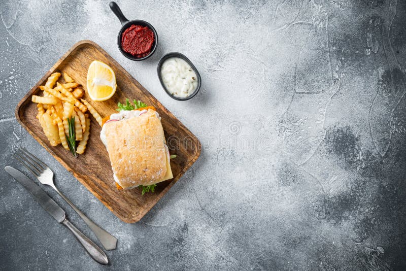 Fresh made Snack Sandwich with Fish Sticks, on gray background, top view flat lay , with copyspace and space for text royalty free stock image.