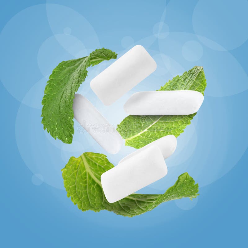 Fresh Mint Leaves and Chewing Gum Pads Falling on Blue Background Stock