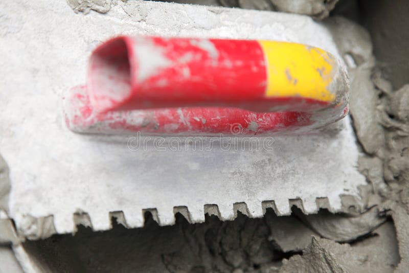 Fresh Mortar Mix with Spatula Tool in Bucket Tile Floor Adhesive Stock