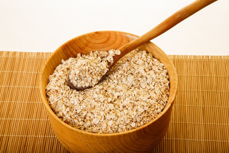 Oats in Wood Bowl on Bamboo Mat