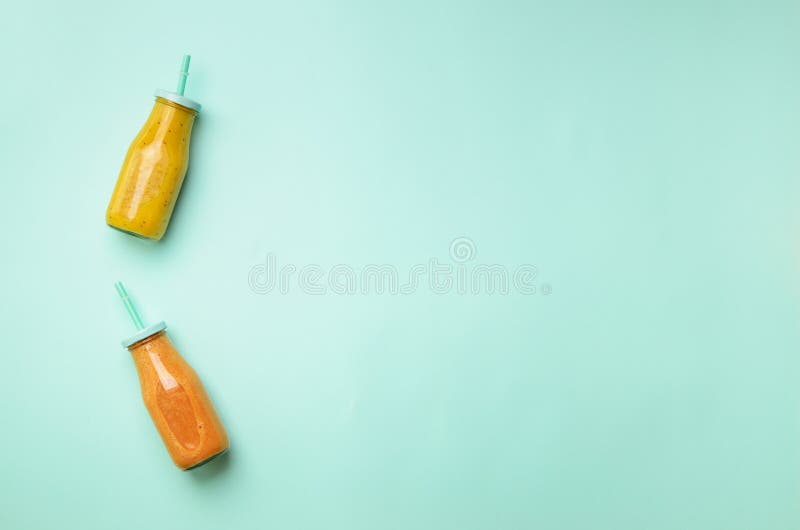 Fresh orange, banana, pineapple, mango smoothies and juicy fruits on blue background. Detox summer drink. Vegetarian concept. Top royalty free stock images Fresh orange, banana, pineapple, mango smoothies and juicy fruits on blue background. Detox summer drink. Vegetarian concept. Top royalty free stock images