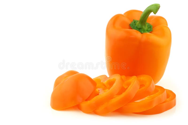 Fresh orange bell pepper and a cut one on a white background