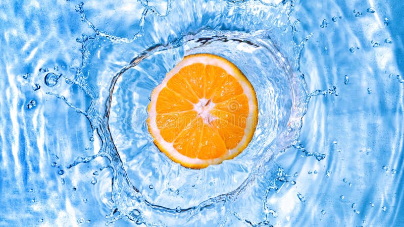 Fresh orange dropped into water