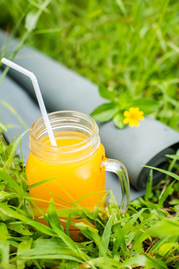 Fresh Orange Juice and Yoga Mat on the Grass Stock Image Image of