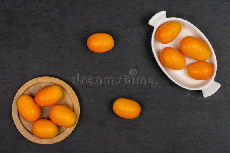 Fresh orange kumquat on grey stone royalty free stock photo Fresh orange kumquat on grey stone royalty free stock photo