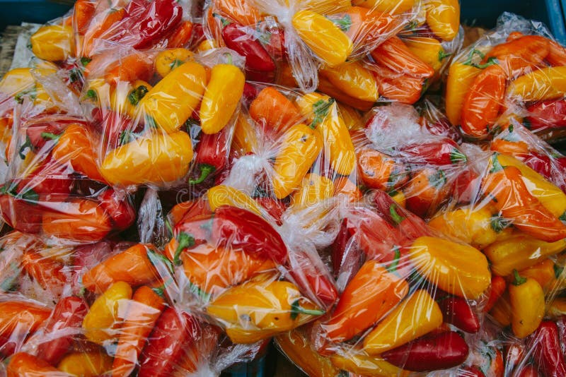 Download Fresh Orange, Red And Yellow Peppers I Plastic Bags At Market In Amsterdam Stock Photo - Image ...
