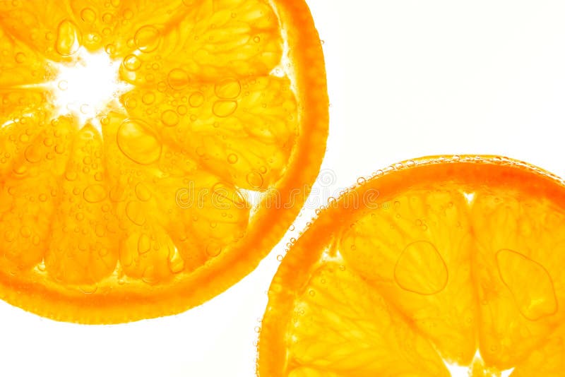 Fresh orange slice in water with bubbles